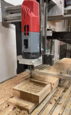 The CNC machine milling a wooden soap holder